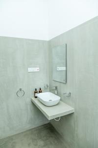 a bathroom with a white sink and a mirror at Rise - Bed & Breakfast in Weligama +102 photos