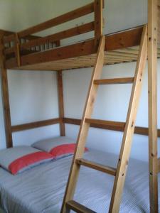 a wooden bunk bed with a ladder on it at La Crielloise in Criel-sur-Mer