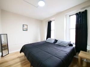 a bedroom with a large bed and a window at Comfy 1-Bedroom Escape Close to NYC with Wifi in Paterson