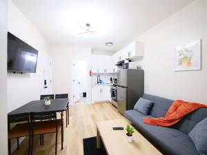 a living room with a blue couch and a table at Comfy 1-Bedroom Escape Close to NYC with Wifi in Paterson