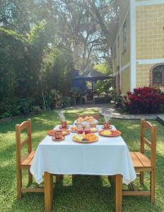 a table with plates of food on top of it at Hospedaje Los Pavo Reales in Tepoztlán +37 photos