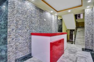 a fireplace in a lobby with a brick wall at Hotel O Om Shanti International in Jādabpur