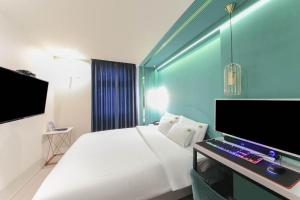 a bedroom with a bed and a desk with a computer at Sasang ND 1226 Hotel in Busan