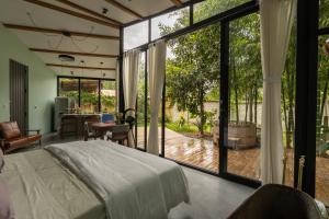 a bedroom with a bed and a large window at Romantic Mirror-Clad Tiny with Private Hot Tub in Pedro Ruiz Gallo