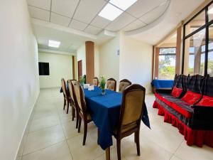 a dining room with a blue table and chairs at Hotal D Palacio Real in San Miguel