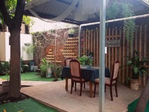 a table and chairs under a blue umbrella at Hotal D Palacio Real in San Miguel