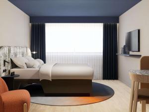 Ένα ή περισσότερα κρεβάτια σε δωμάτιο στο Mercure Hotel Den Haag Central