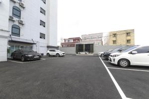 a parking lot with cars parked in front of a building at Sasang ND 1226 Hotel in Busan
