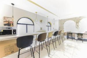 a kitchen with a bar with chairs and a counter at Sasang ND 1226 Hotel in Busan