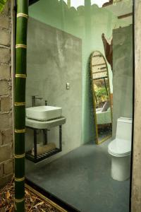 a bathroom with a sink and a toilet at Romantic Mirror-Clad Tiny with Private Hot Tub in Pedro Ruiz Gallo