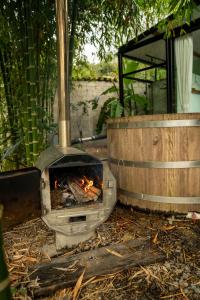a fire pit in a yard with at Romantic Mirror-Clad Tiny with Private Hot Tub in Pedro Ruiz Gallo