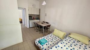 a room with a bed and a kitchen with a table at La Escondida in Juana Koslay 