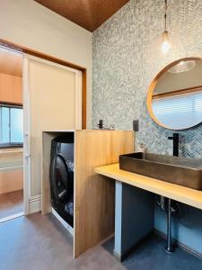 a bathroom with a sink and a microwave at Anju KAGUYA 香宮宿 in Katori