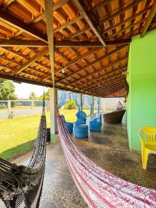 a hammock on a porch of a house at Pousada da Ana in Estivado