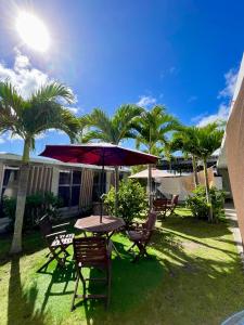 座間味村にあるLagoon315の傘とヤシの木が並ぶテーブルと椅子