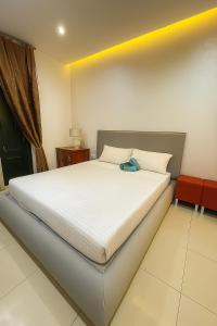 a bedroom with a white bed with a blue bag on it at Modern Gzira 2BR Apartment Race2 in Il-Gżira