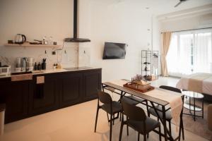 a kitchen and dining room with a table and chairs at CBD Loft Studio 3B, Heart of Multatuli food scene, Walkable, Private compound, High Security in Medan