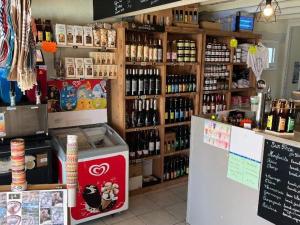 a store with a counter with bottles of alcohol at Mobil home avec terrasse à Gurmençon - API-1-52-612 in Gurmençon