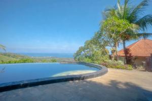 a swimming pool with a view of the ocean at Maria Secret Villa in Lovina