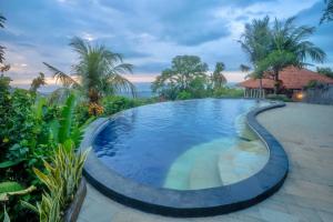 a swimming pool in the middle of a resort at Maria Secret Villa in Lovina