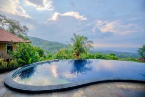 a swimming pool with a view of the mountains at Maria Secret Villa in Lovina +33 photos