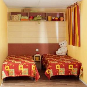 a room with two beds and a teddy bear at Camping 3 étoiles - Piscine - eeed0b in Bédouès