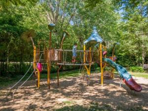 a child playing on a playground in a park at Camping 3 étoiles - Piscine - eeed0b in Bédouès
