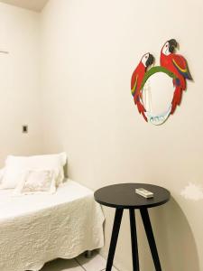 a bedroom with a bed and a table with a mirror at Pousada da Ana in Estivado +4 photos