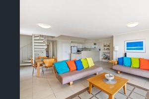 a living room with two couches and a table at Unit 15 - 45 Lorikeet Drive, Peregian Beach in Peregian Beach