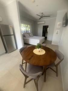 a kitchen and dining room with a table and chairs at Reid's Retreat - Studio Apartment in Port Douglas