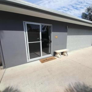a house with a window and a bench in front of it at Reid's Retreat - Studio Apartment in Port Douglas