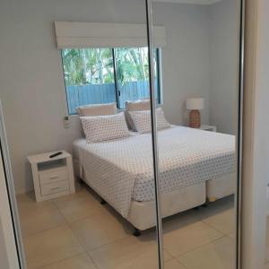 a bedroom with a bed and a window at Reid's Retreat - Studio Apartment in Port Douglas