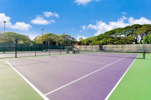 a tennis court with two people playing tennis at Papakea K103 · PK K103 Ocean views Condo | Lanai + AC + Pool in Kaanapali