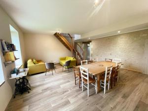 a dining room with a wooden table and chairs at Gîte à Manthelan : Confort et Charme, Jardin, Wi-Fi - FR-1-381-639 in Monfoué