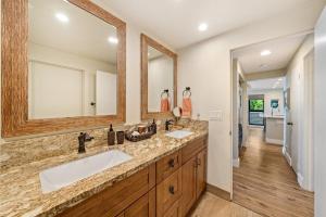 a bathroom with two sinks and two mirrors at Kahana Village 36 · KHV 36 Oceanfront 3BD Kahana Condo, Beach & in Lahaina +47 photos