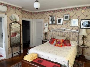 a bedroom with a bed with red pillows on it at Munroe Inn Boutique Hotel in Auburn