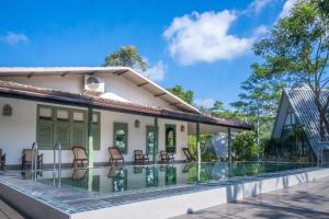 an image of a house with a swimming pool at Sinharaja River Lodge in Nikawatawana