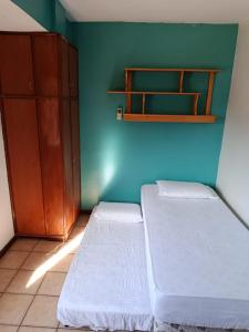 a room with two beds and a blue wall at Villa Anto in Encarnación +14 photos