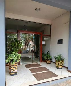 an entrance to a building with potted plants in front at Villa Anto in Encarnación