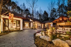 a home with a patio and a pond at Chengdu Xiaoya Courtyard Hot Spring Retreat -- Close to Panda Base & Sanxingdui Museum- Private Hot Spring & Sichuan Cuisine - Chinese Tea Ceremony, Free Breakfast, Afternoon Tea & Goodnight Snacks in Chengdu +169 photos