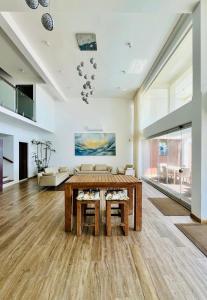 a living room with a table and a couch at Hikka House - Thema Collection in Hikkaduwa