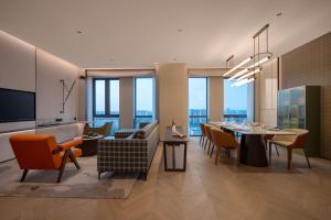a dining room and living room with a table and chairs at Holiday Inn Beijing Daxing Centre by IHG in Beijing