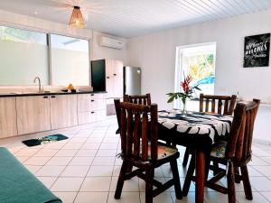 a kitchen with a table and chairs in a room at Manahiti properties in Moorea +15 photos