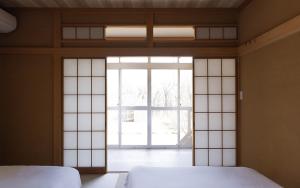 Una cama o camas en una habitación de rinne 那須 Garden 3