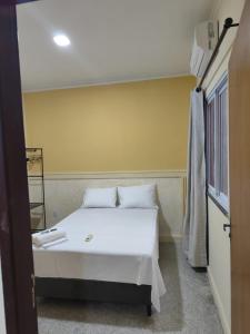 Ένα ή περισσότερα κρεβάτια σε δωμάτιο στο Residencial Laize & Lucas