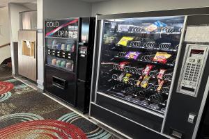 an open refrigerator filled with lots of soda at Coratel Inn and Suites by Jasper Stillwater in Stillwater