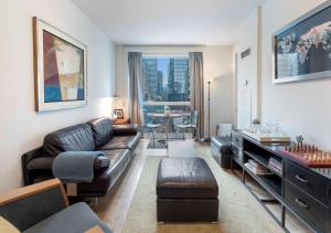 a living room with a couch and a table at Luxury 1-Bedroom Condo in Yorkville, Downtown Toronto in Toronto