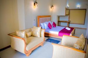 Postel nebo postele na pokoji v ubytování Hotel Grand Utopia