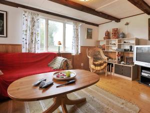 a living room with a red couch and a table at 5 person holiday home in KLIPPAN-By Traum in Hagstad