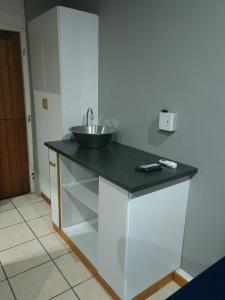 a kitchen with a counter with a sink on it at WegkruiperQ in Beaufort West +5 photos